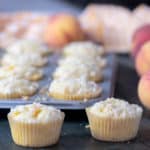 An easy recipe for peach cobbler muffins that is simple and delicious. Fresh Ontario peaches in a light fluffy muffin with a buttery crumble topping.