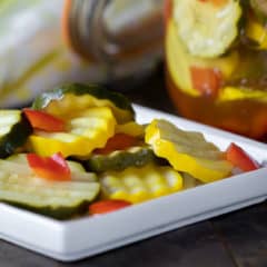 Quick recipe for small batch refrigerator zucchini pickles. Made with both green and yellow zucchini squash, red peppers, garlic, dill, and mustard seeds.