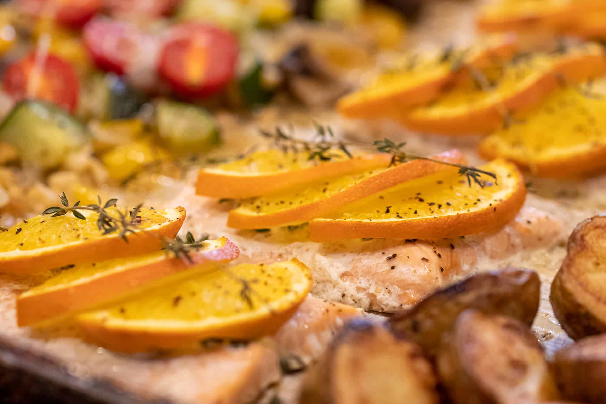 Close up with frozen salmon, sliced oranges and thyme