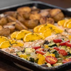 Easy recipe to make a one pan meal with frozen salmon fillets, mini potatoes and mixed vegetables. Delicious weeknight sheet pan dinner!