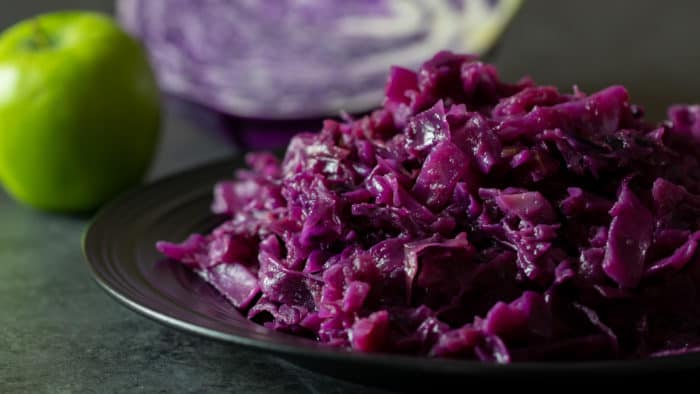 A finished photo of the red cabbage and apples that were braised in a dutch oven.