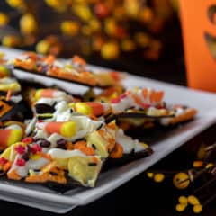 Chocolate bark recipe with a holiday Halloween theme. Sweet dessert treat made with dark chocolate melts, coloured candy melts, candy corn and sprinkles.