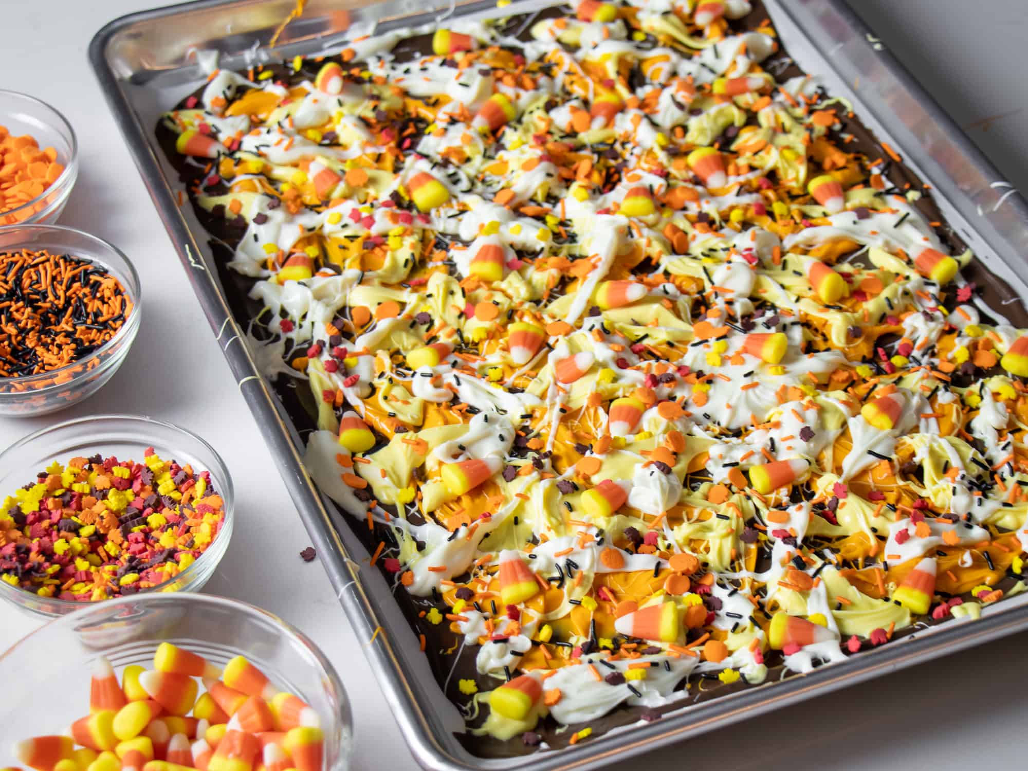 Top with candy corn and sprinkles all over the melted chocolate.