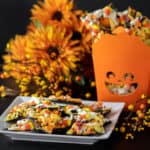 Chocolate bark recipe with a holiday Halloween theme. Sweet dessert treat made with dark chocolate melts, coloured candy melts, candy corn and sprinkles.