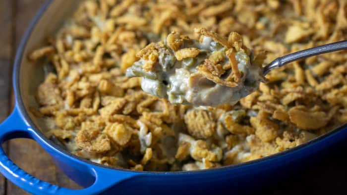 Traditional green bean casserole recipe made with cream of mushroom soup and crispy fried onions. The best holiday Thanksgiving side dish.