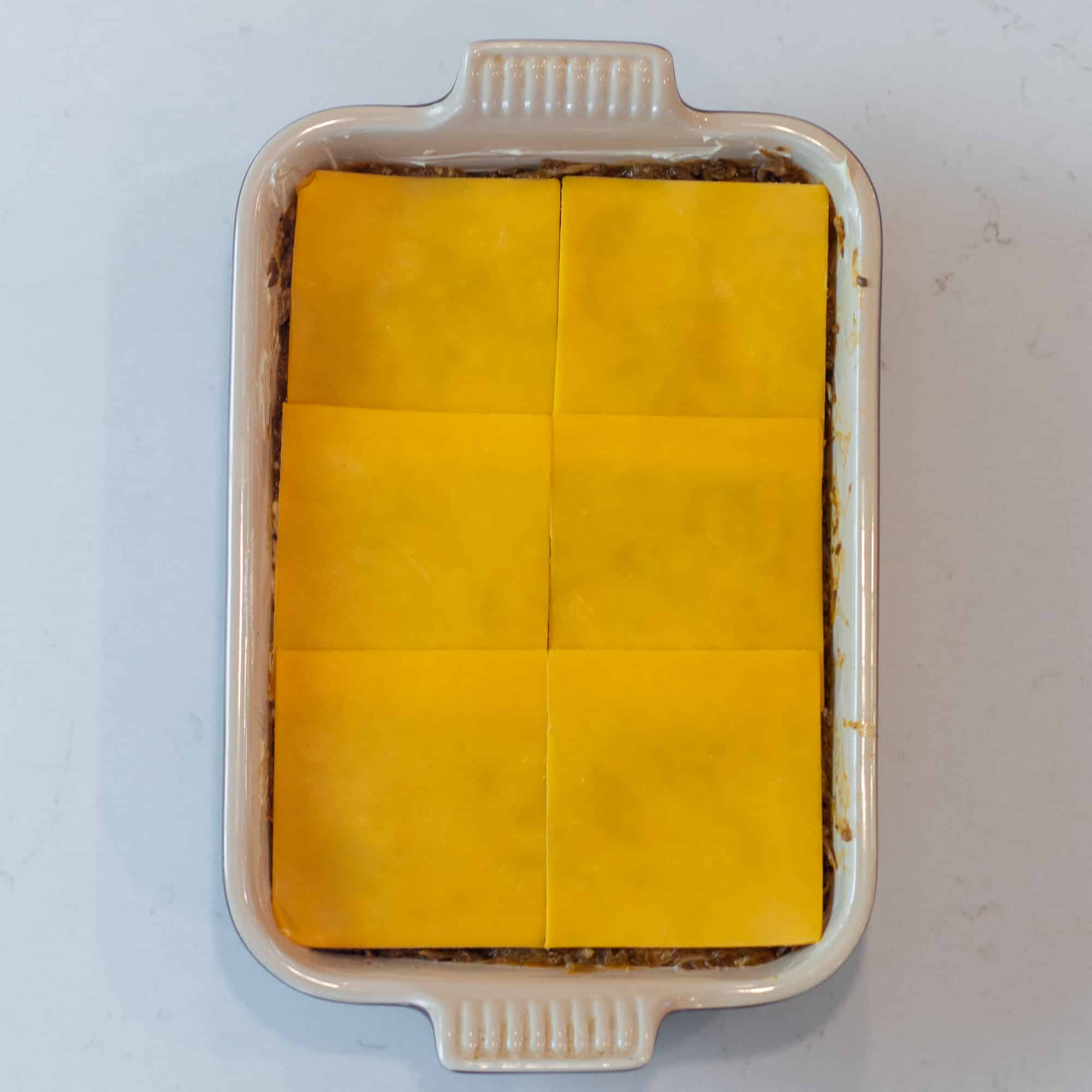 Lay the cheese slices down.