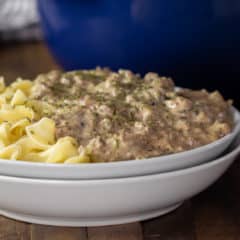 A bowl of creamy beef stroganoff on a bed of egg noodles.