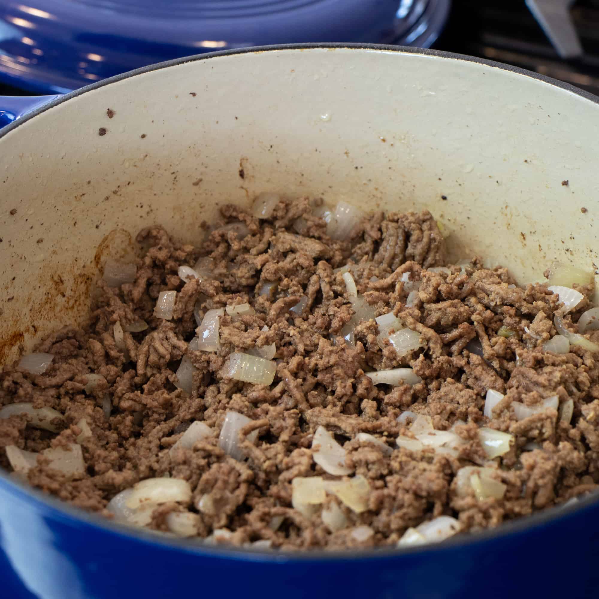 Ground beef and diced onions sautéed in a dutch oven.