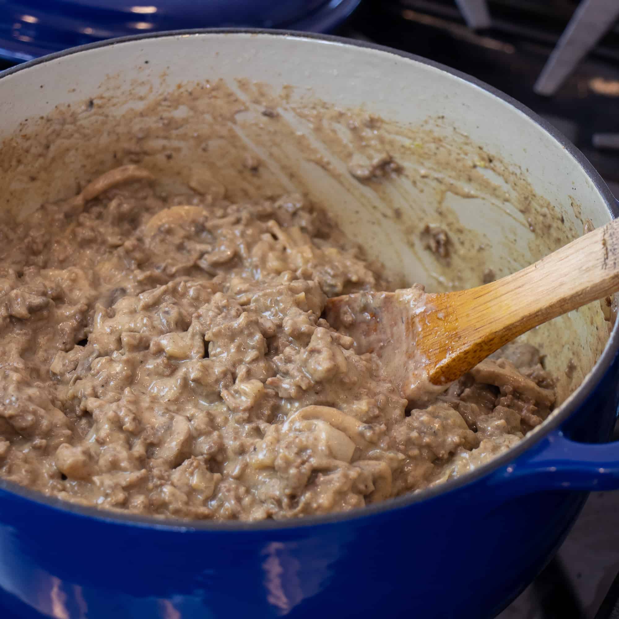 Stir in the cream of mushroom soup, Worcestershire sauce and seasoning to the ground beef and mushrooms.