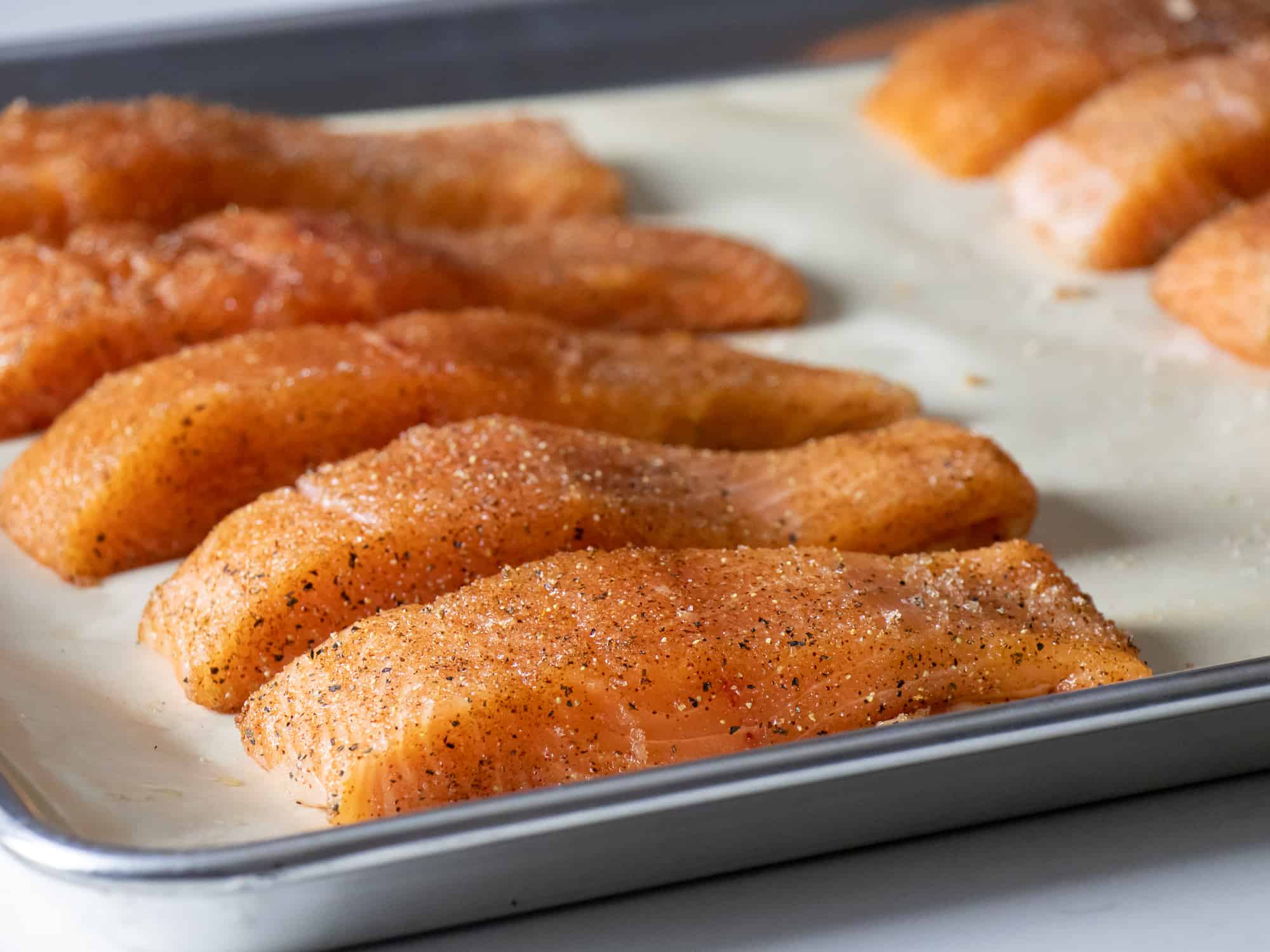 Place the salmon fillets on a baking sheet lined with parchment paper