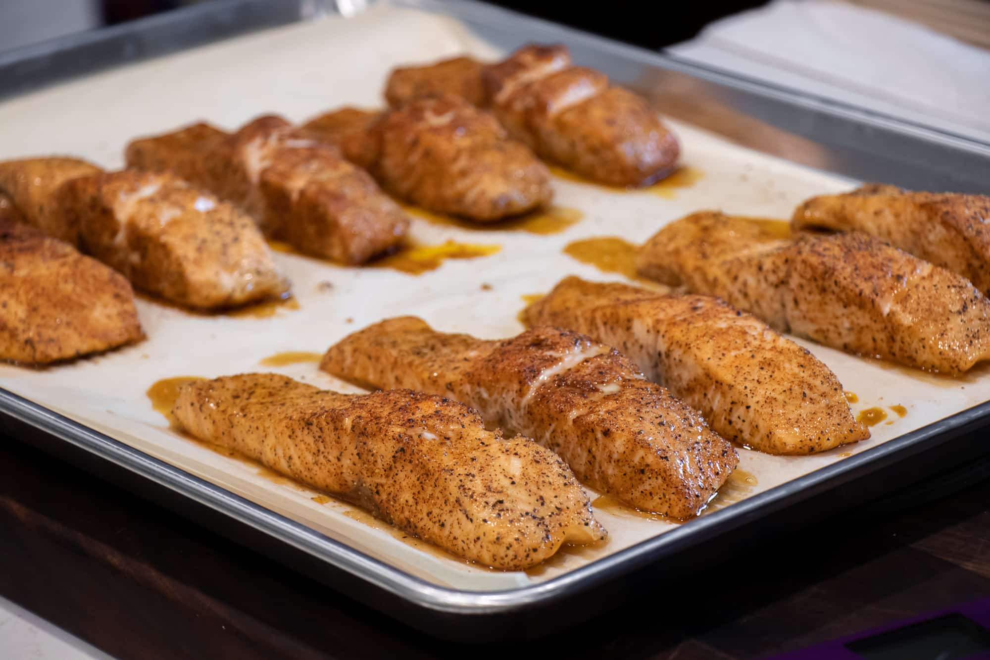 Sheet of salmon fillets baked until done and reach internal temperature of 145F.