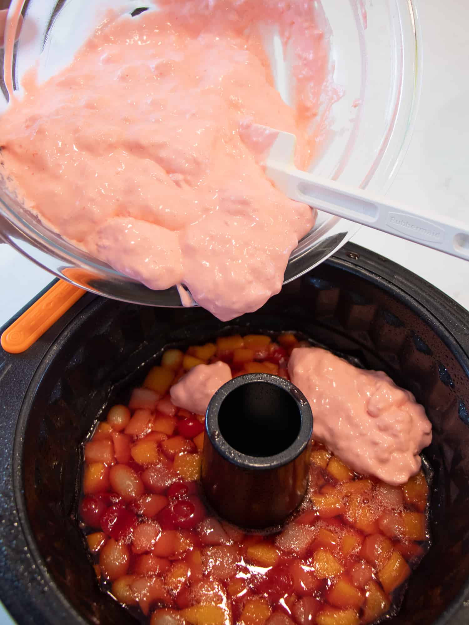 Spread the Jello and whipped cream mixture on top of the Jello with mixed fruit.