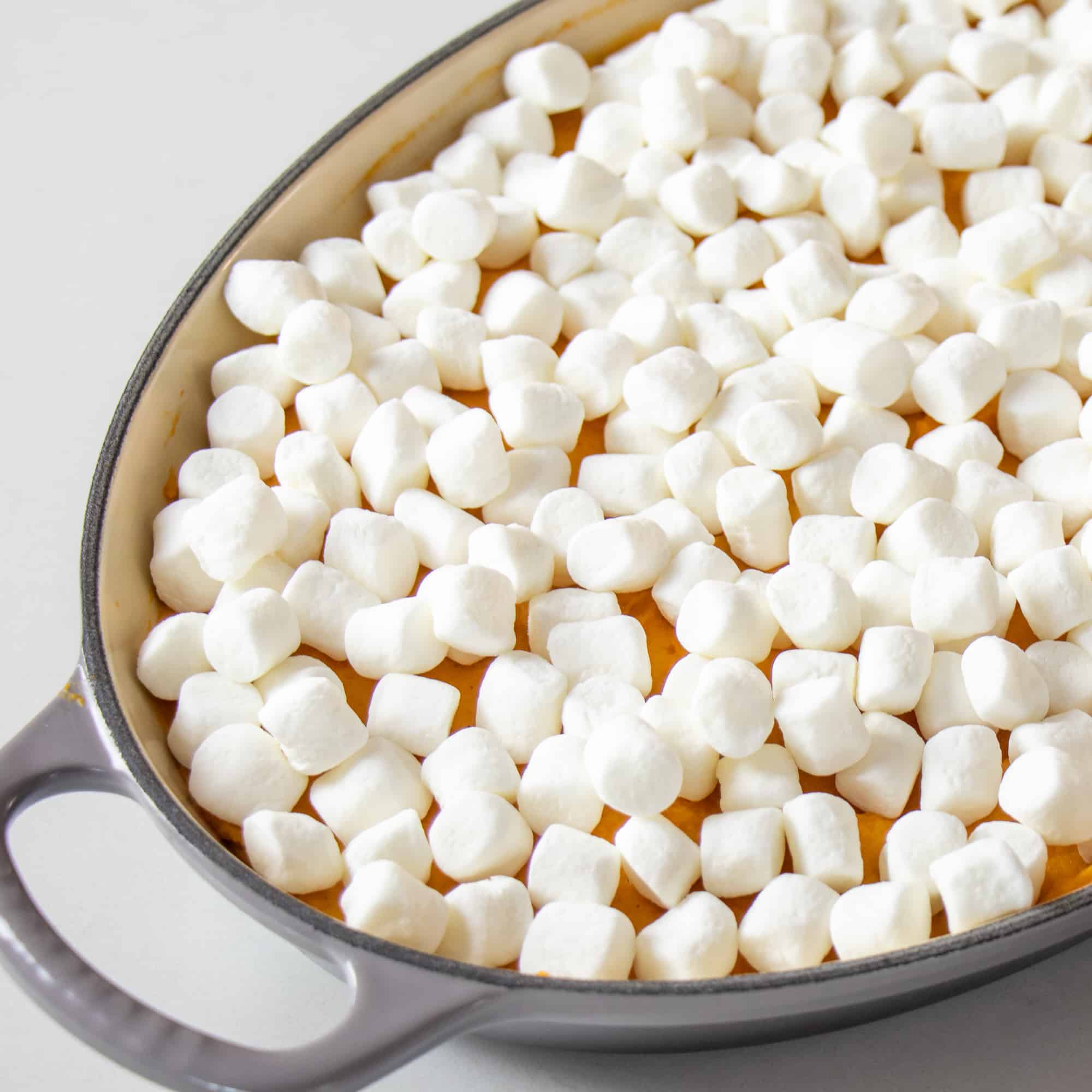 Spread the mini marshmallows on top of the sweet potatoes.