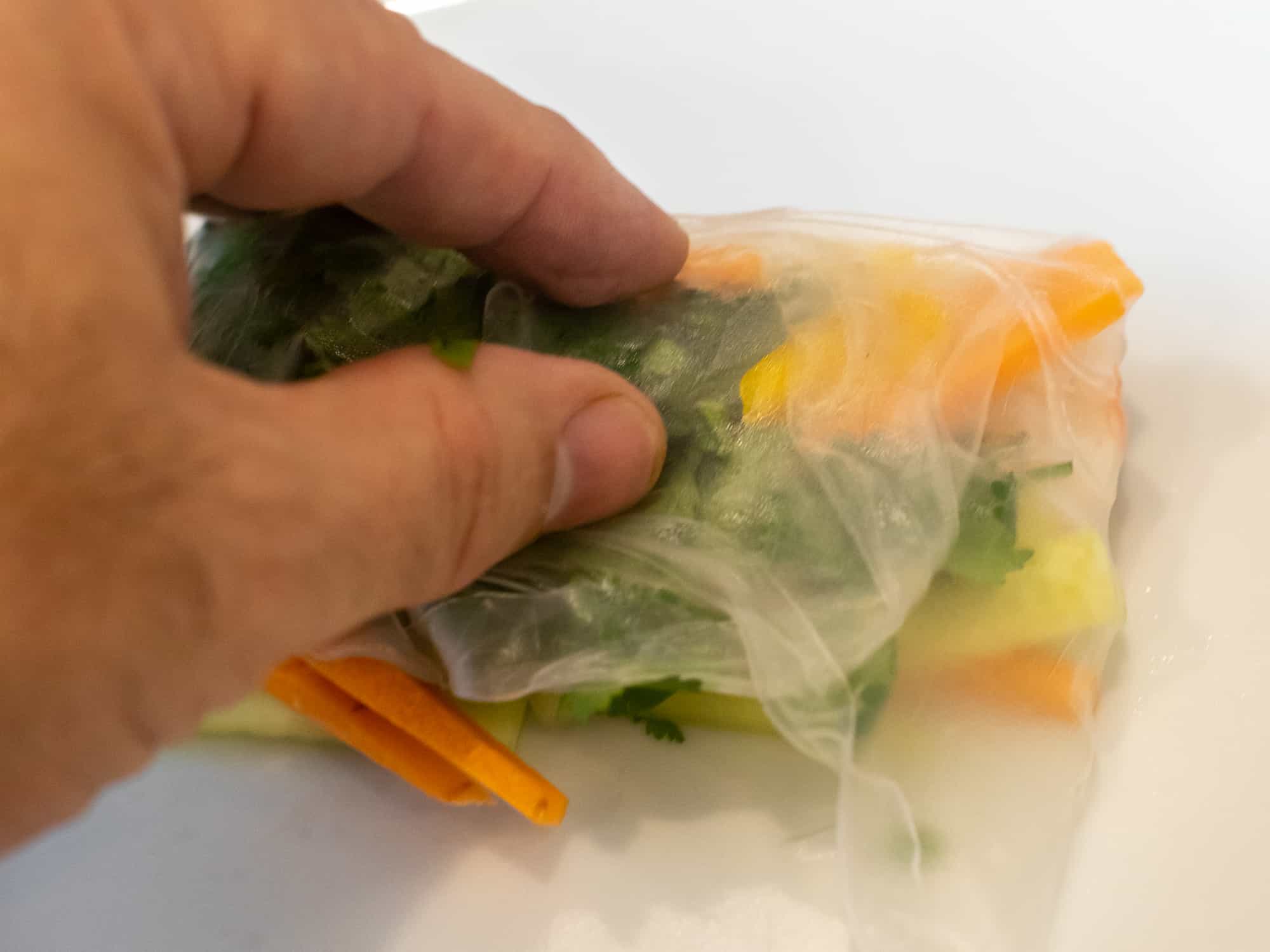 Pull the sides of the rice paper into the centre and press down to stick.