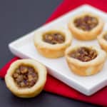 Maple syrup and pecans make up the filling in these mini tarts tassies that are simple and delicious. Cream cheese and butter pastry.