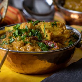 A bowl of matar paneer with fresh cilantro