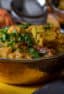 A bowl of matar paneer with fresh cilantro