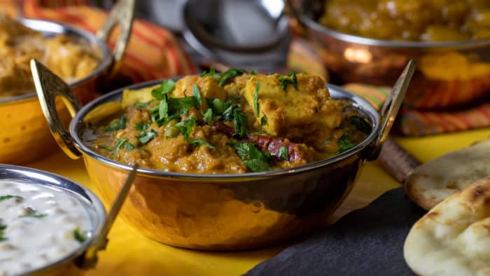 A bowl of matar paneer with fresh cilantro