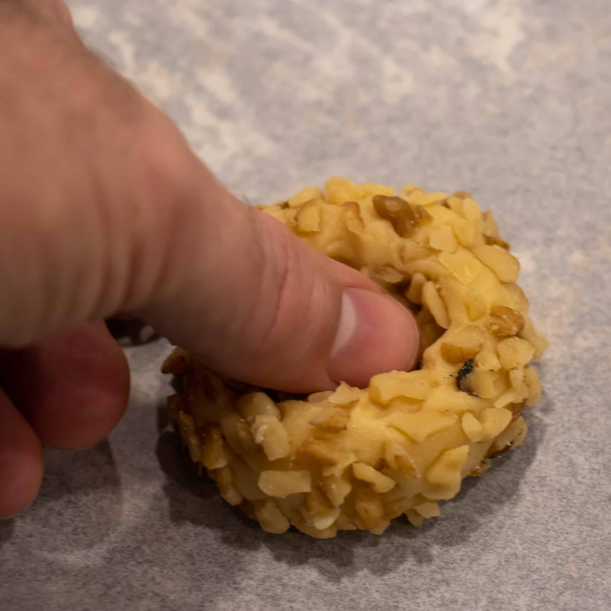 Place on a baking sheet and press the centre with your thumb.