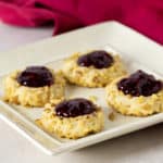 Plate of raspberry filled thumbprint cookies.