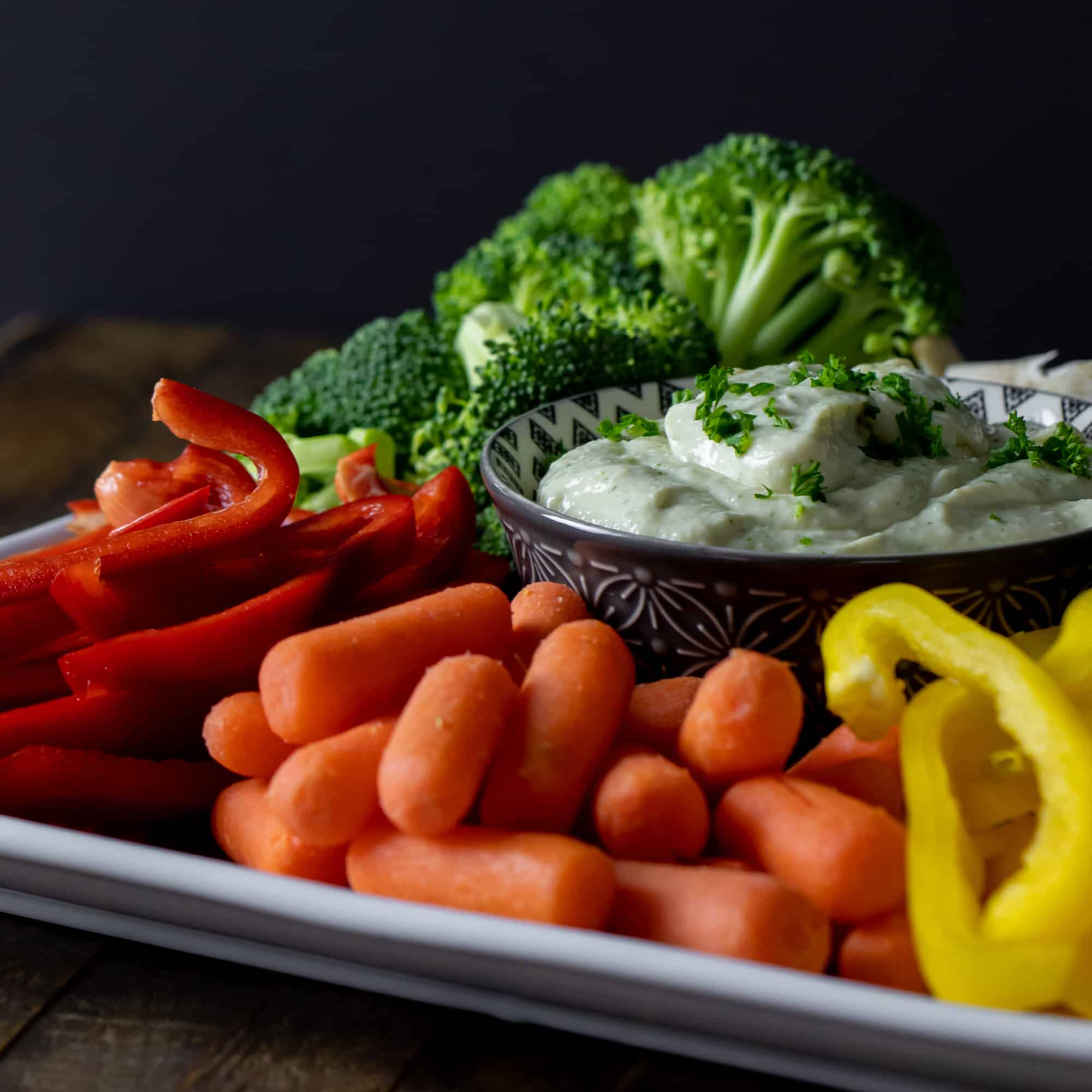Plate or cut up raw vegetables with a bowl of creamy dip.