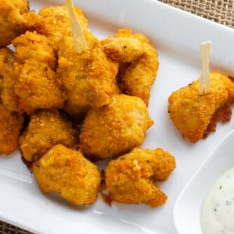 An overhead picture of a plate of nuggets with dipping sauce.
