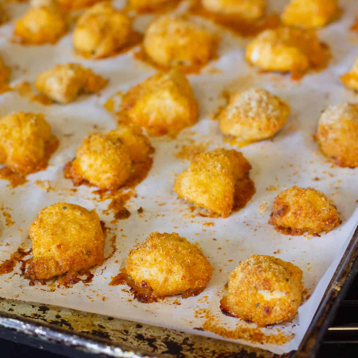 Cooked nuggets on a baking sheet.