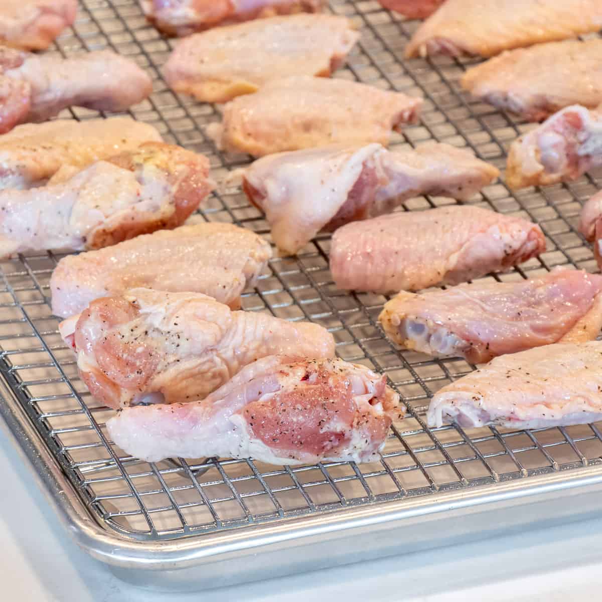 Chicken wings placed on a rack and ready to go in the oven.