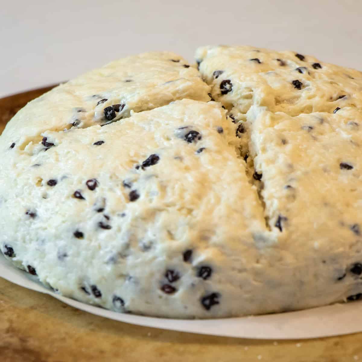 A deep cross cut into the top of the dough.