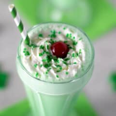 Overhead picture of a milkshake with whipping cream.