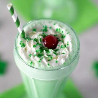 Overhead picture of a milkshake with whipping cream.