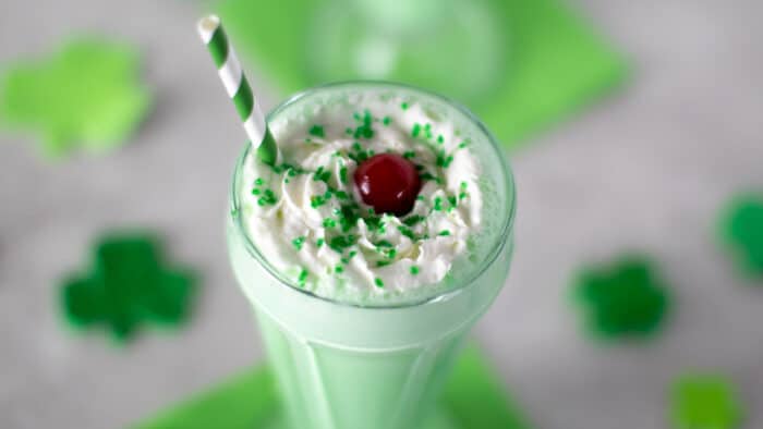 Overhead picture of a milkshake with whipping cream.