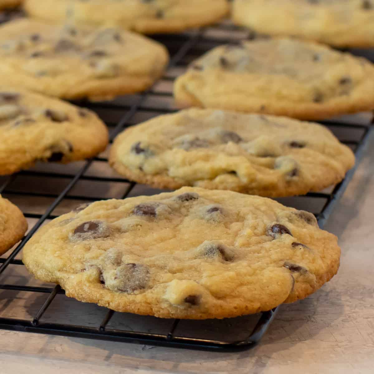 A close up of a cookie on a cooling rack.