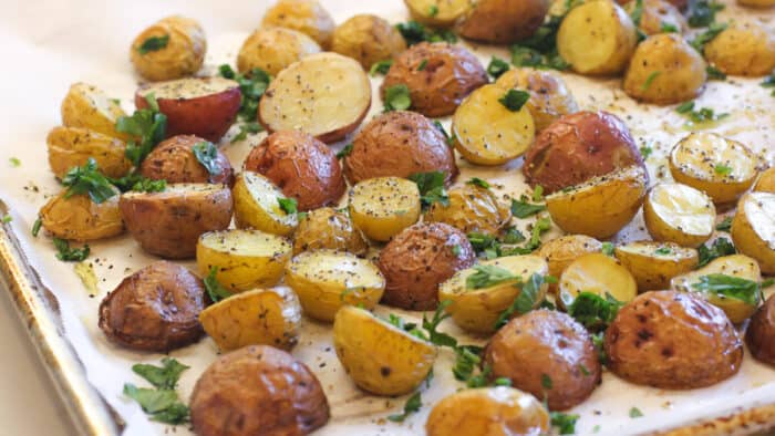 A baking sheet of mini potatoes.