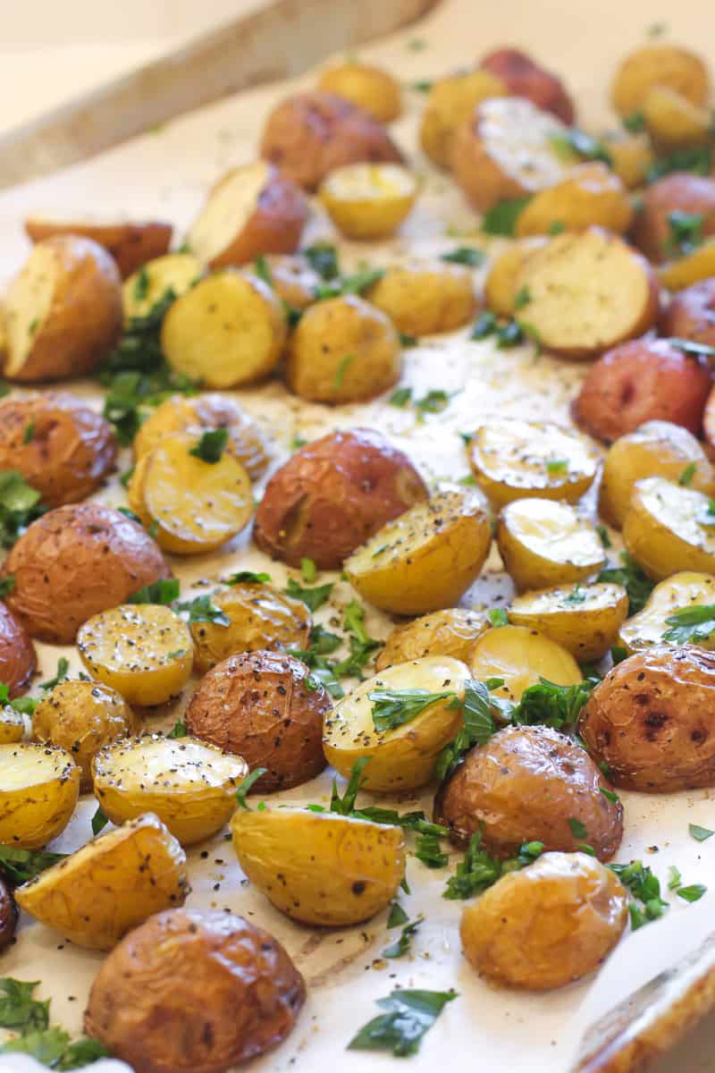 Halved potatoes on a baking sheet.
