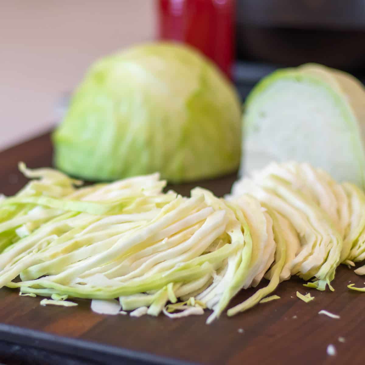 Slicing cabbage on a cutting board.