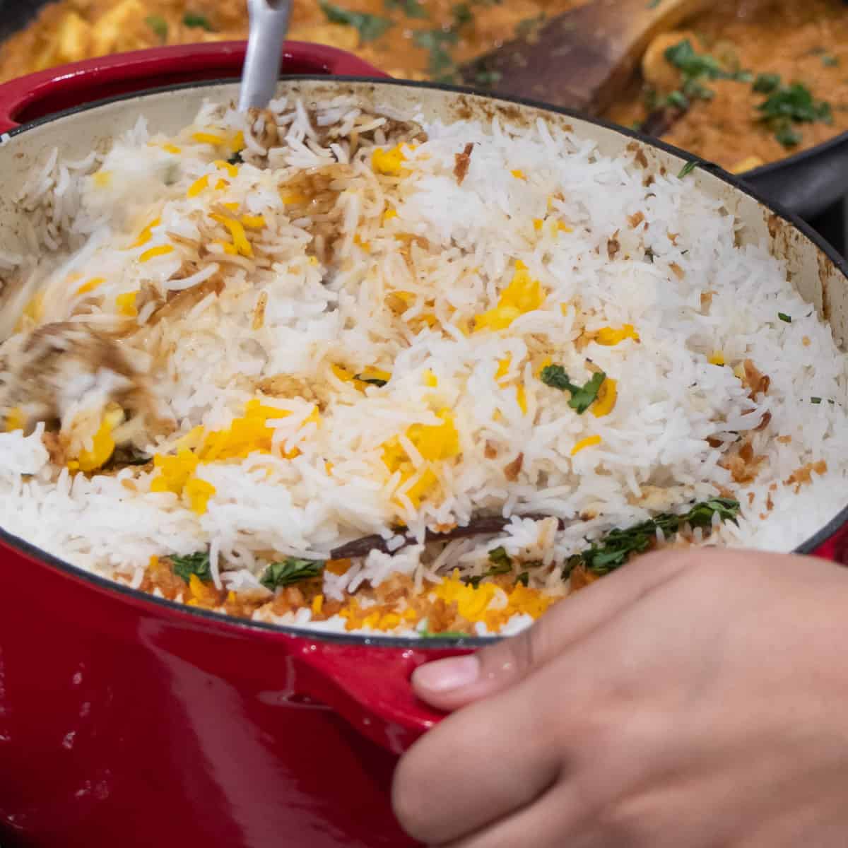 Turning the rice in with the meat curry.