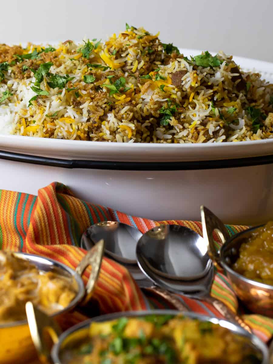 An Indian meal with biryani, matar paneer and butter chicken.