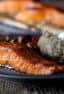 A plate of grilled salmon and a baked potato.