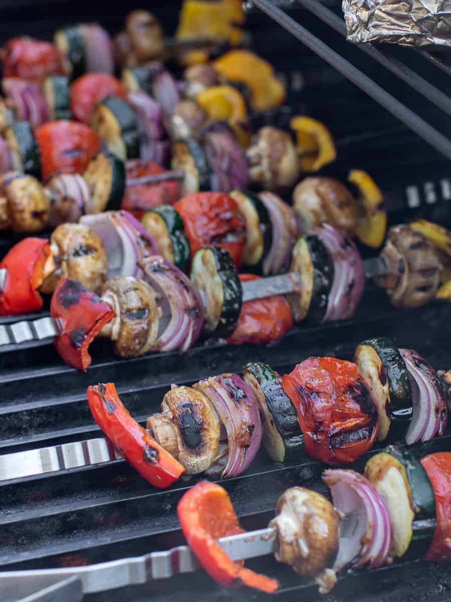 Vegetable skewers ready to come off the grill.