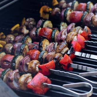 Skewers of vegetables on a grill.