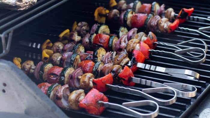 Skewers of vegetables on a grill.