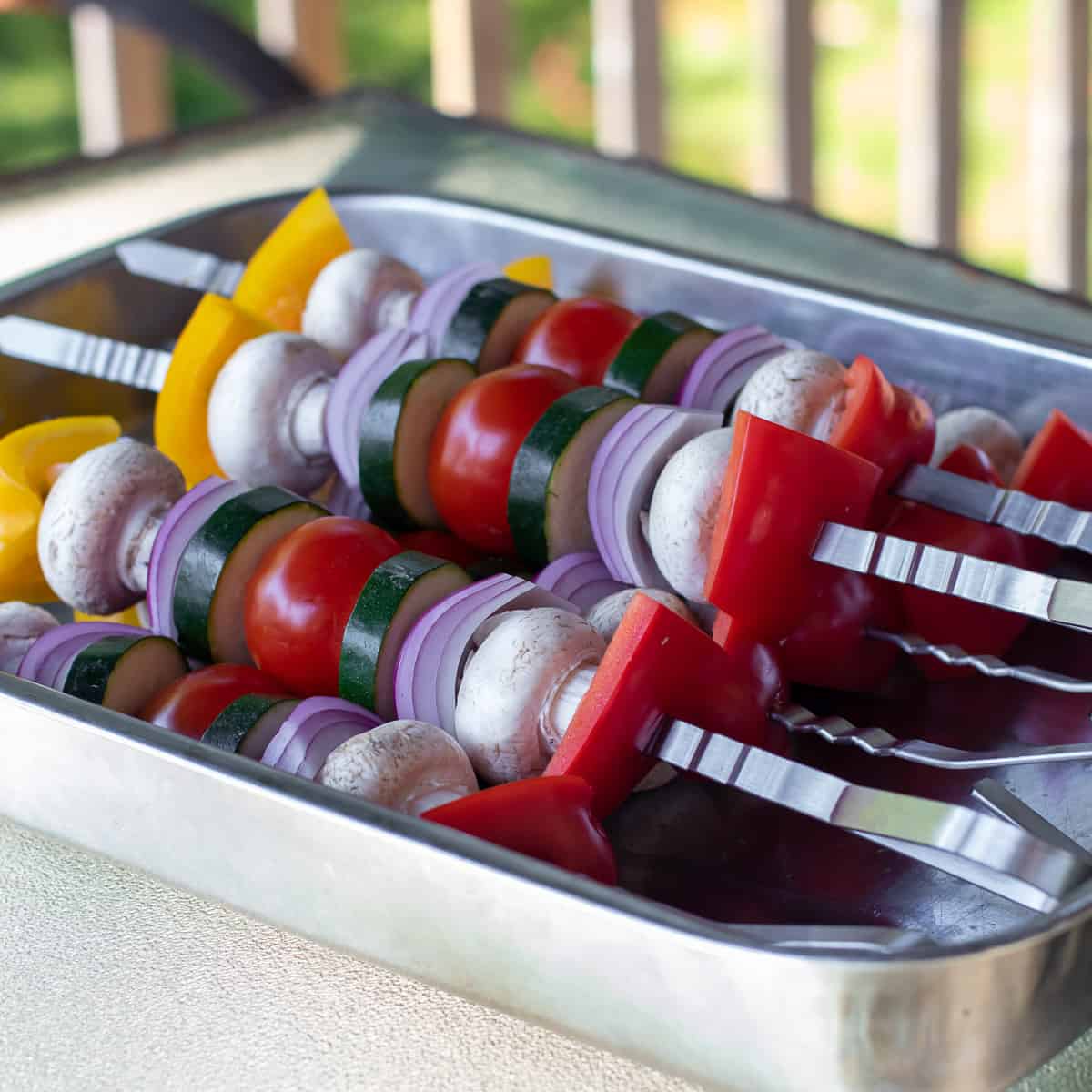 A tray of skewers ready to go on the grill.