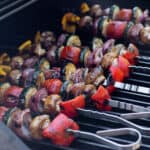 BBQ veggie skewers on a hot grill.
