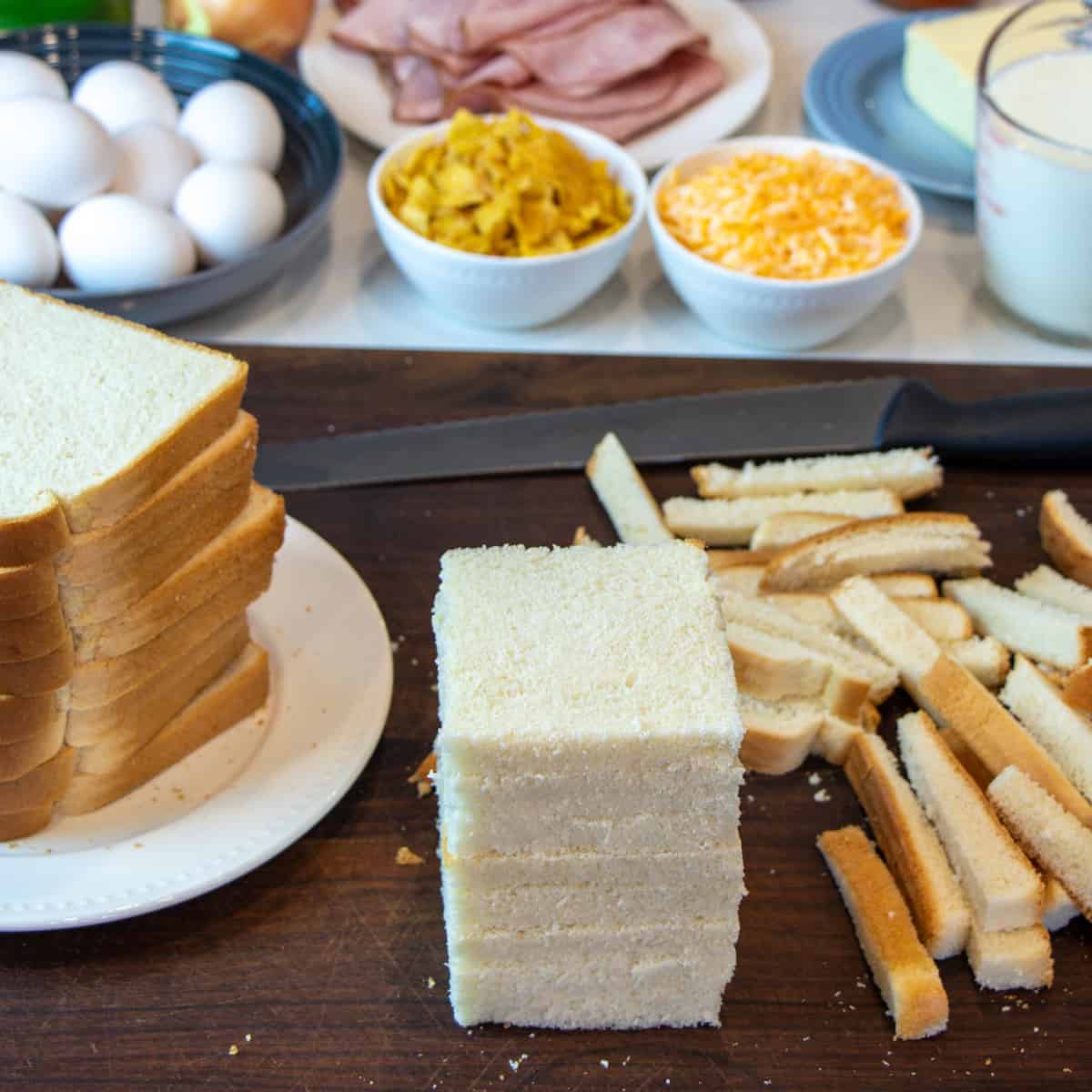 A stack of bread slices with the crusts removed.