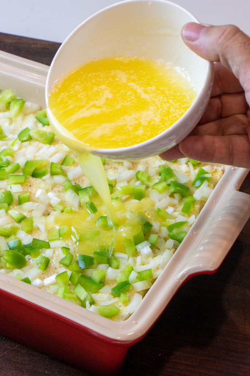 Melted butter being poured on top just before it goes in the oven to bake.