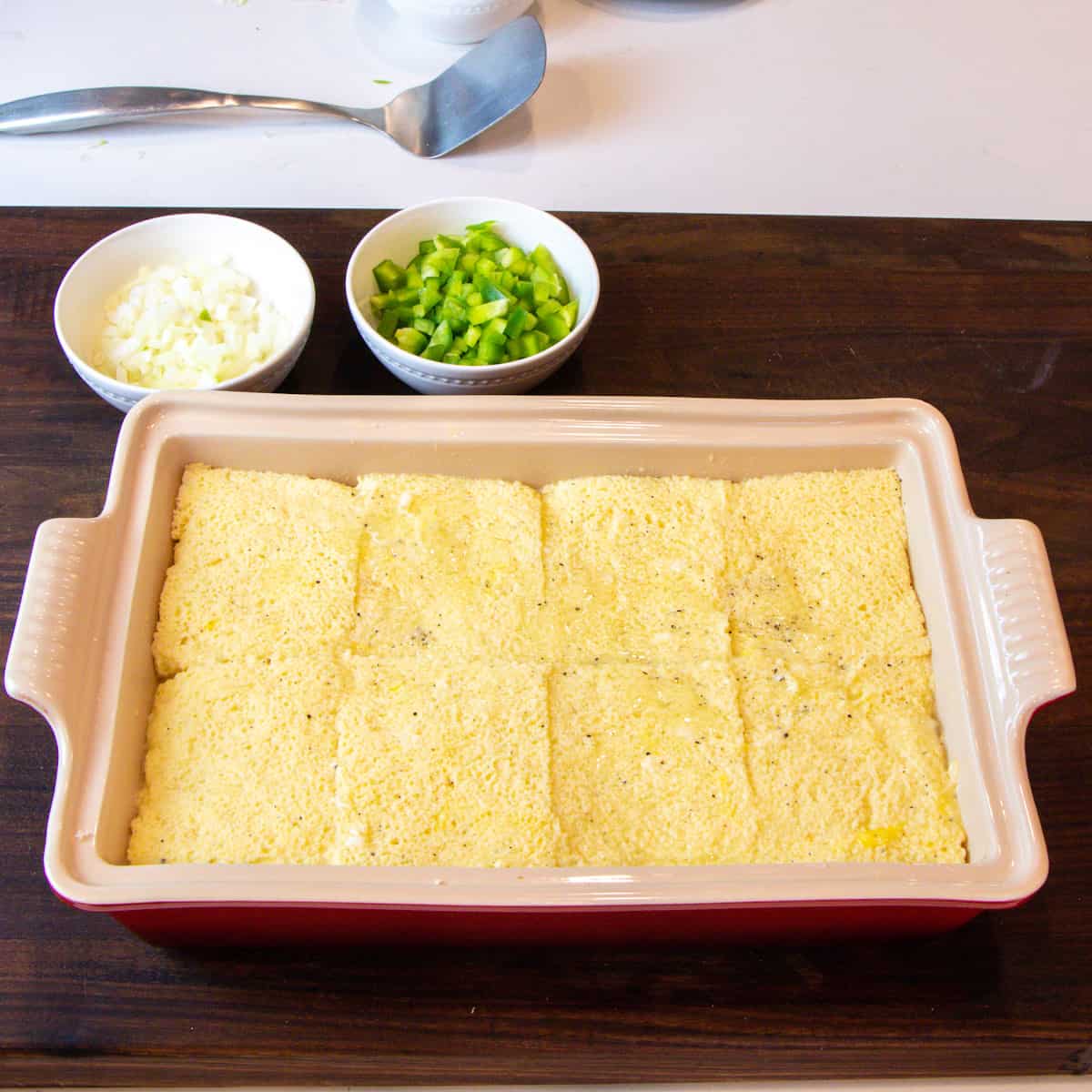 A casserole dish with slices of bread soaked in egg mixture.