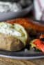 A dinner plate with salmon, grilled vegetables and potato..
