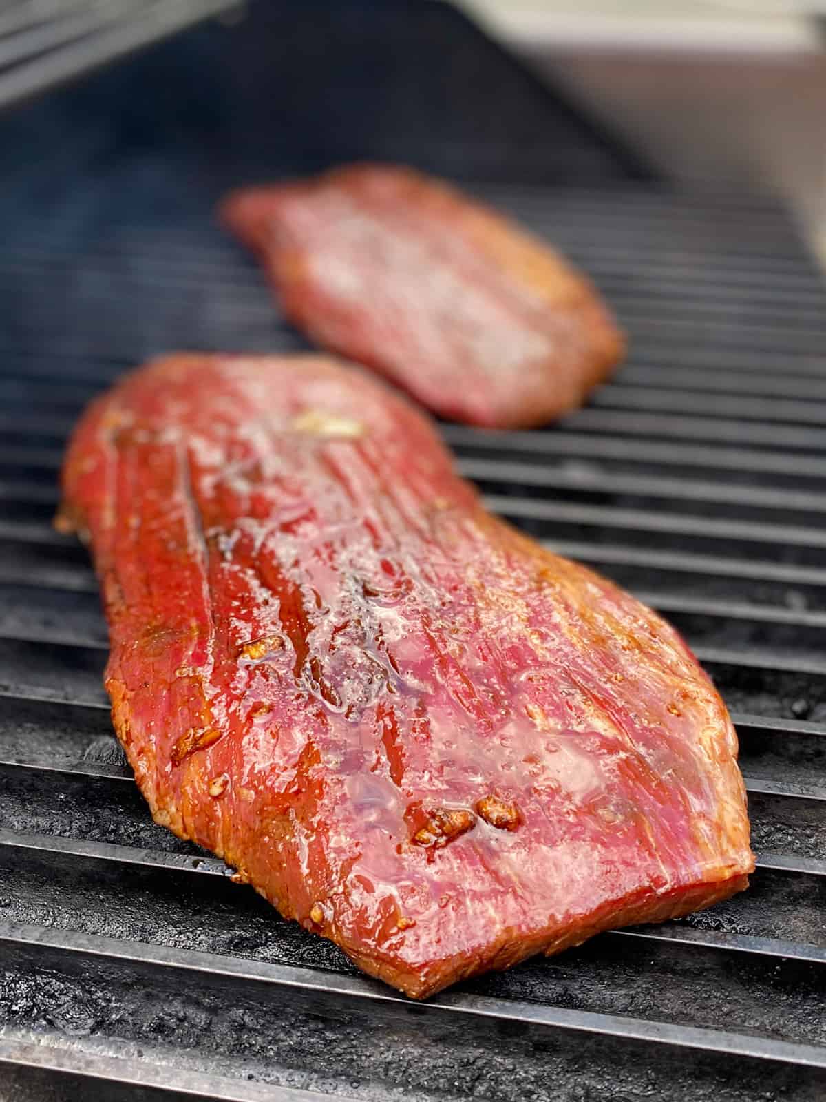 Flank steaks on a hot grill.