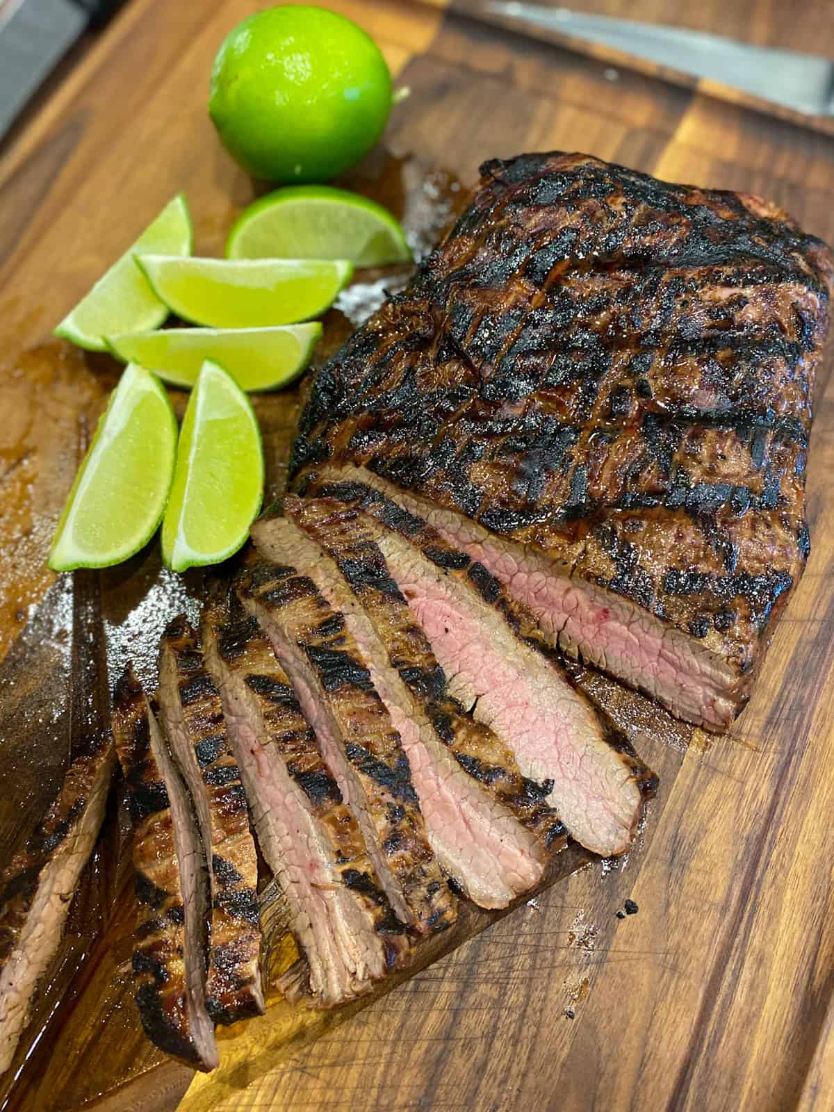 Sliced flank steak on a cutting board.